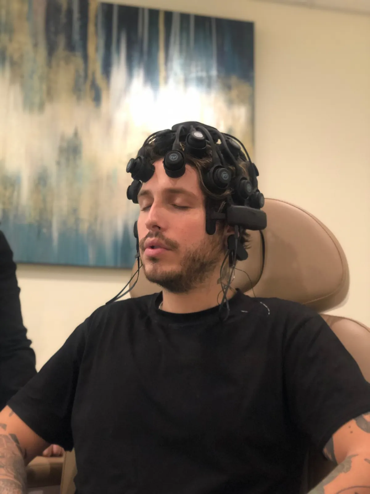 Patient undergoing qEEG brain mapping for concussion assessment with the Freedom 20R headset